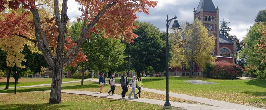 view of Thompson Hall with students in Autumn
