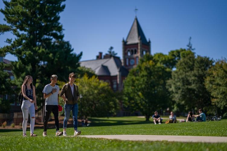 Students walking in front of Thompson Hall in summer